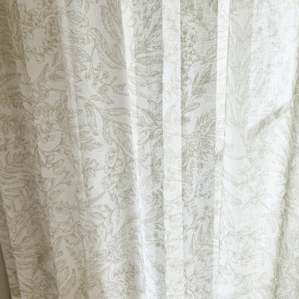 a close up of a curtain with a cat on it