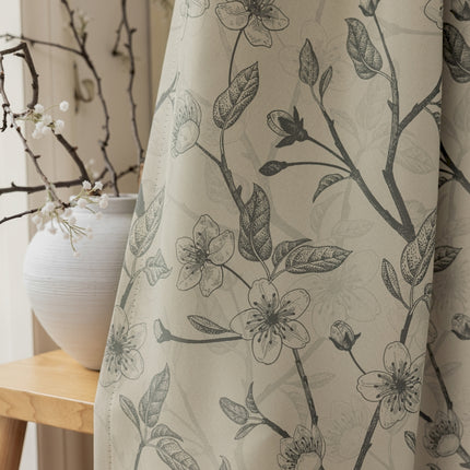 a white vase sitting next to a window covered in a curtain