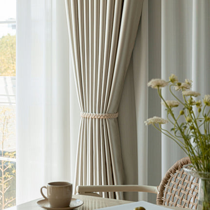 a vase of flowers sitting on a table next to a window