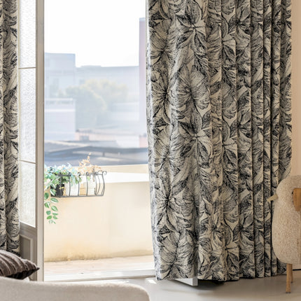 a chair sitting in front of a window next to a window
