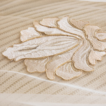 a close up of a bed with a decorative design on it