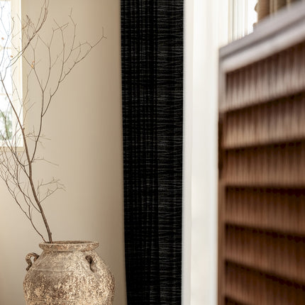 a vase sitting on a table next to a window