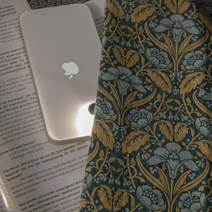 an apple computer sitting on top of a book