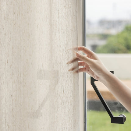 a person's hand reaching out of a window