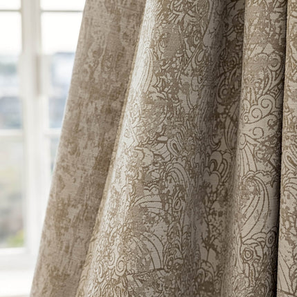 a close up of a curtain with a window in the background