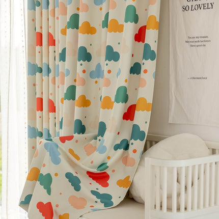 a white crib next to a window with a curtain