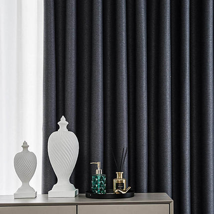 a white vase sitting on top of a dresser next to a window