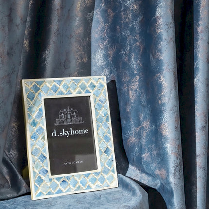 a picture frame sitting on top of a blue chair