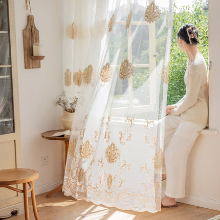 a woman sitting on a window sill looking out the window