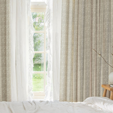 a bed with a white comforter and a window