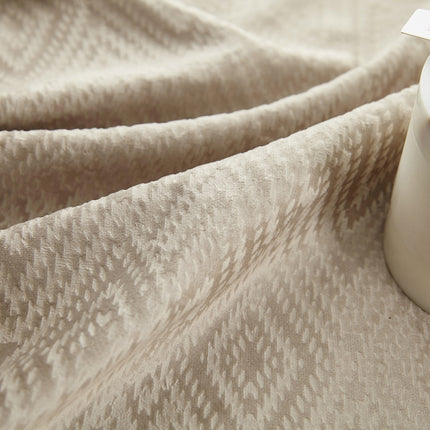 a bottle of lotion sitting on top of a blanket
