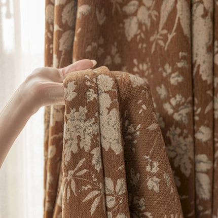a person's hand holding a curtain in front of a window