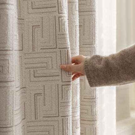 a person holding a curtain with their hand