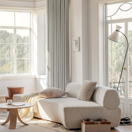 a living room filled with furniture and large windows