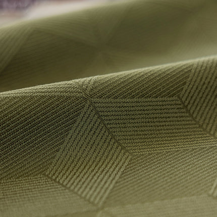 a close up of a green fabric with a diamond pattern