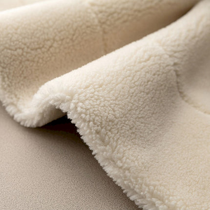 a close up of a white blanket on a bed