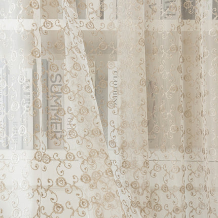 a window with a curtain that has a pattern on it