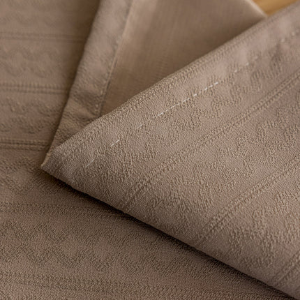 a close up of a bed with a sheet on it