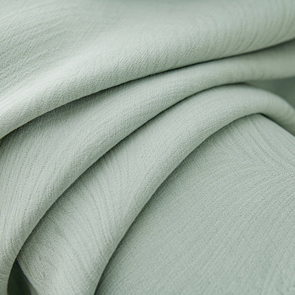 a close up of a light green fabric