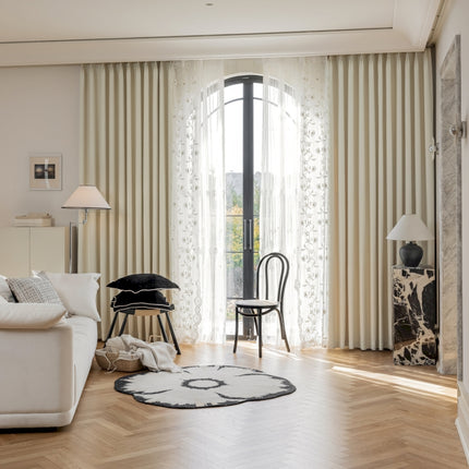 a living room filled with furniture and a large window
