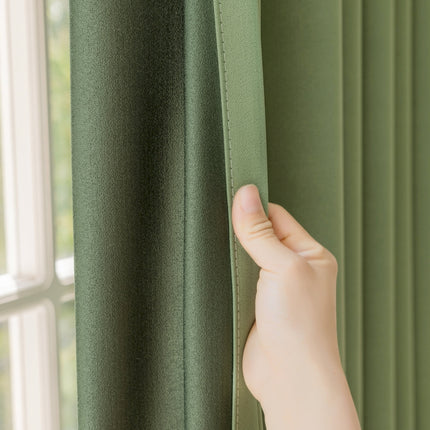 a hand is holding a curtain in front of a window