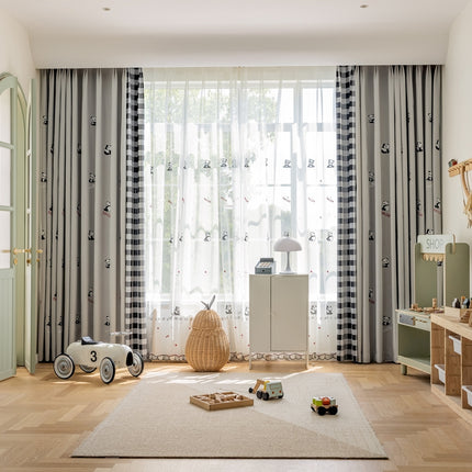 a child's room with a large window and a rug on the floor