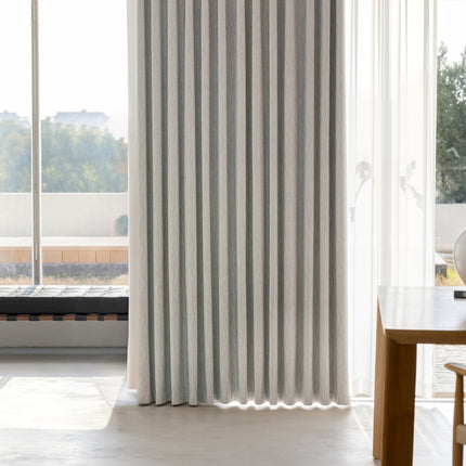 a room with a table, chair and a window