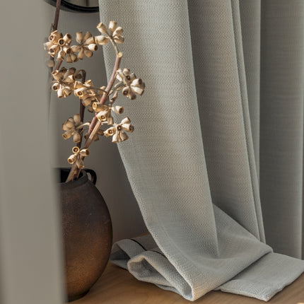 a close up of a flower on a curtain