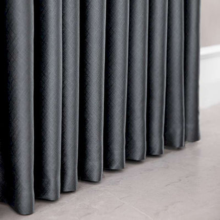 a row of black curtains sitting on top of a floor