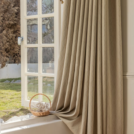 a window with a curtain and a basket on the window sill