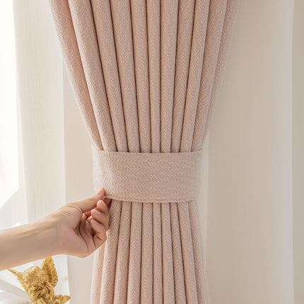 a person is pulling up a curtain with their hand