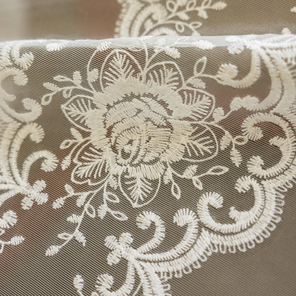 a close up of a white lace on a piece of cloth