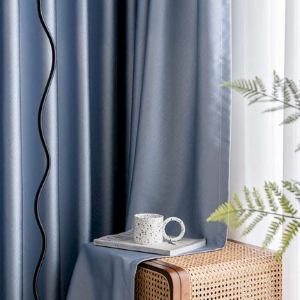 a coffee cup sitting on top of a table next to a window