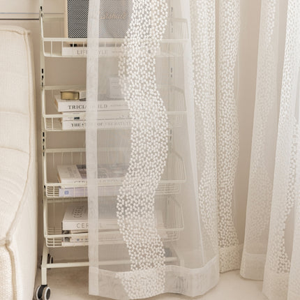 a room with a white curtain and a white chair