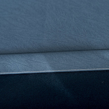 a close up of a blue sheet on a bed