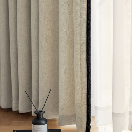 a black and white vase sitting on top of a wooden floor