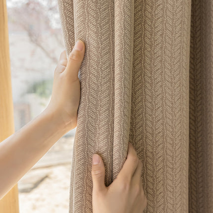 a person is opening a curtain with their hand