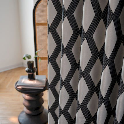a black and white checkered curtain next to a chair