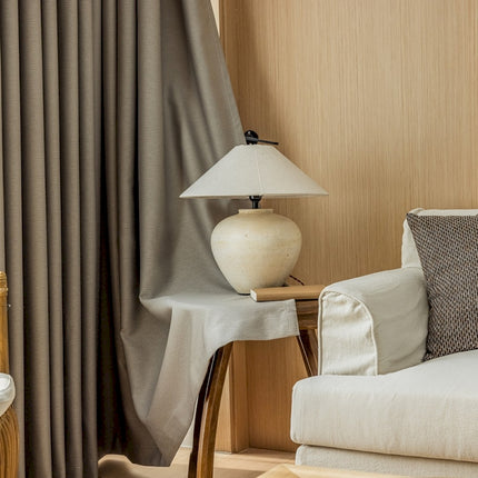 a white couch sitting next to a lamp on a table
