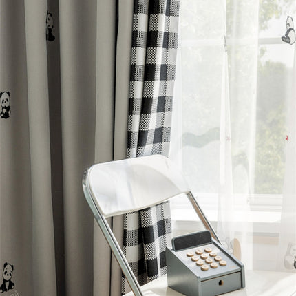 a desk with a phone and a window