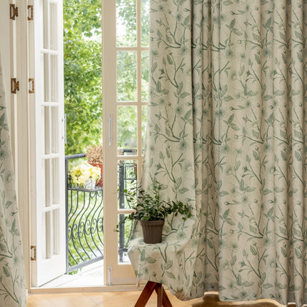 a chair sitting in front of a window next to a potted plant