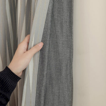 a person holding a curtain with their hand