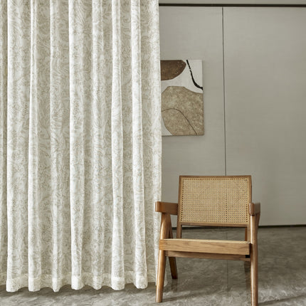 a chair sitting in front of a white curtain