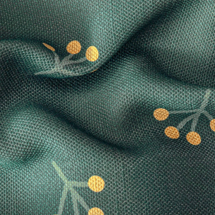 a close up of a green fabric with gold dots