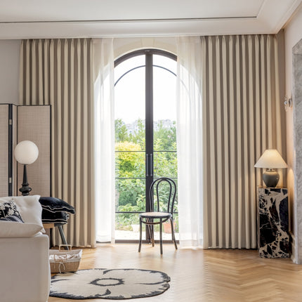 a living room filled with furniture and a large window