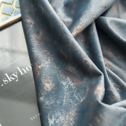 a book laying on top of a blue cloth