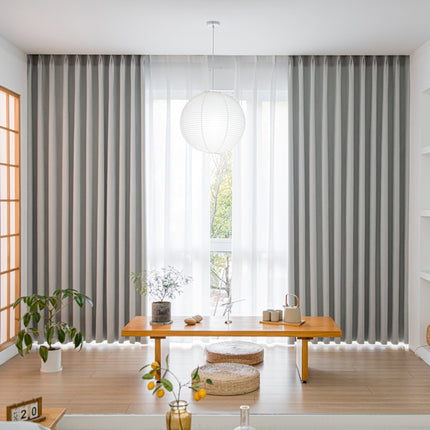 a living room filled with furniture and a large window