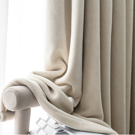 a close up of a curtain with a blanket on it