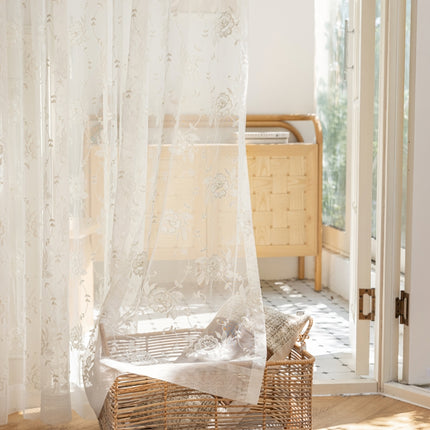 a bedroom with a bed and a basket on the floor