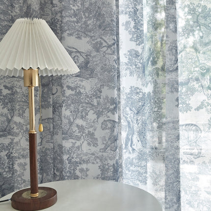 a lamp sitting on top of a table next to a window